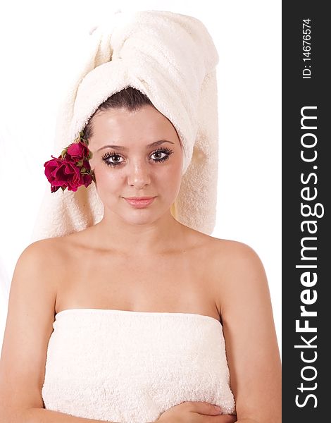 Beautiful spa woman with towel on head and roses