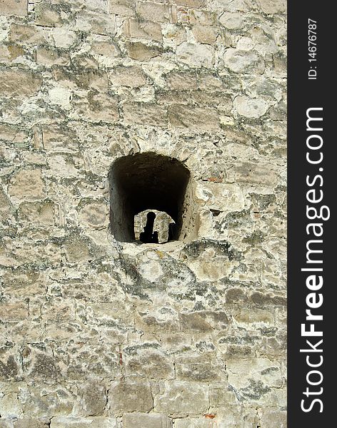 Stronghold stone wall with cannon in embrasure