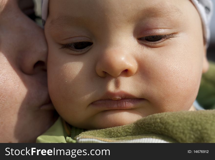 Mother kissing her small son.