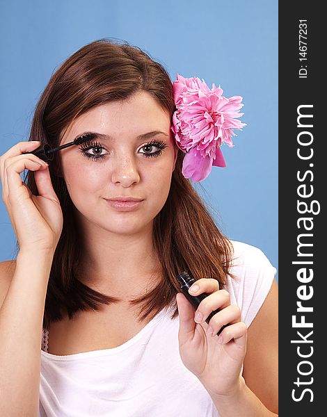 Beautiful woman putting on mascara. Beautiful woman putting on mascara.