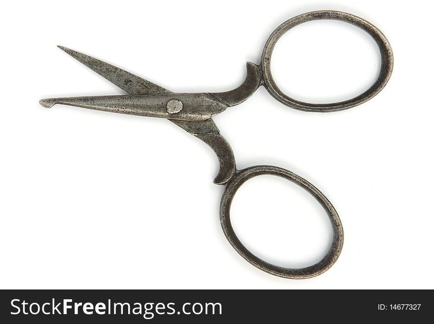 Ancient open scissors on white background