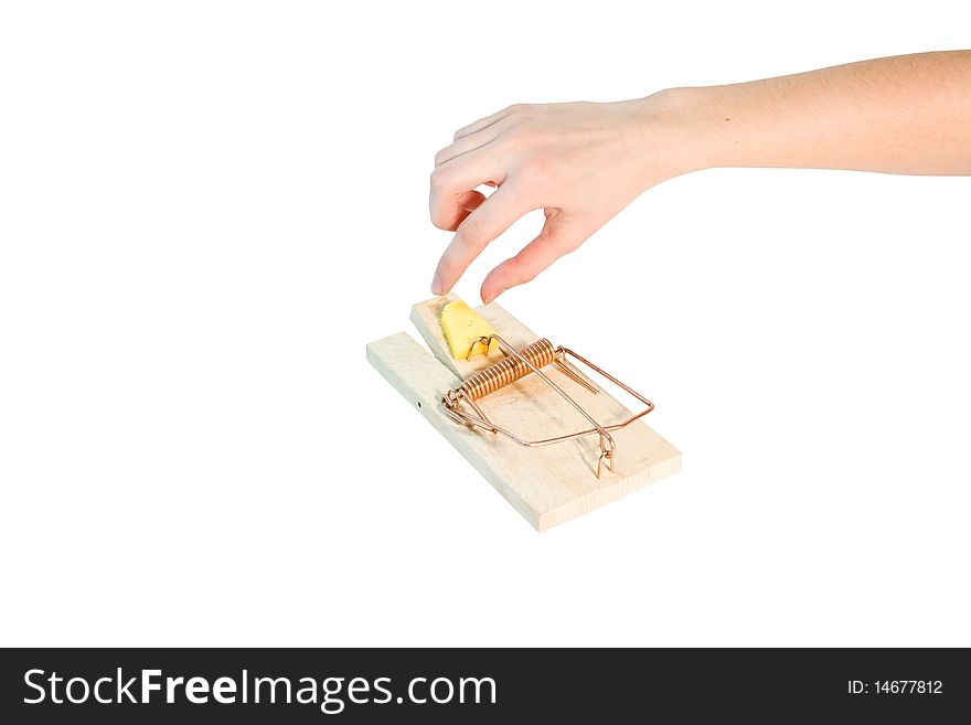 A woman's hand reaching for a cheese in a mousetrap