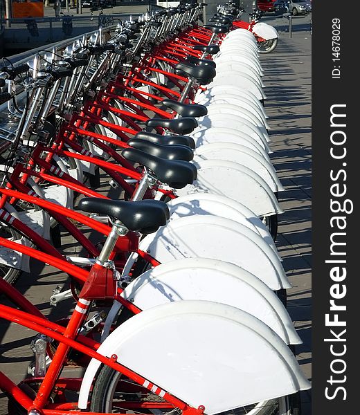 Red bicycles for rent in a row. Red bicycles for rent in a row