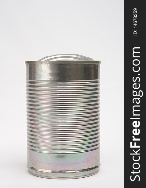 A macro image of a food container made of tin with corrugations and isolated on a plain background. A macro image of a food container made of tin with corrugations and isolated on a plain background.