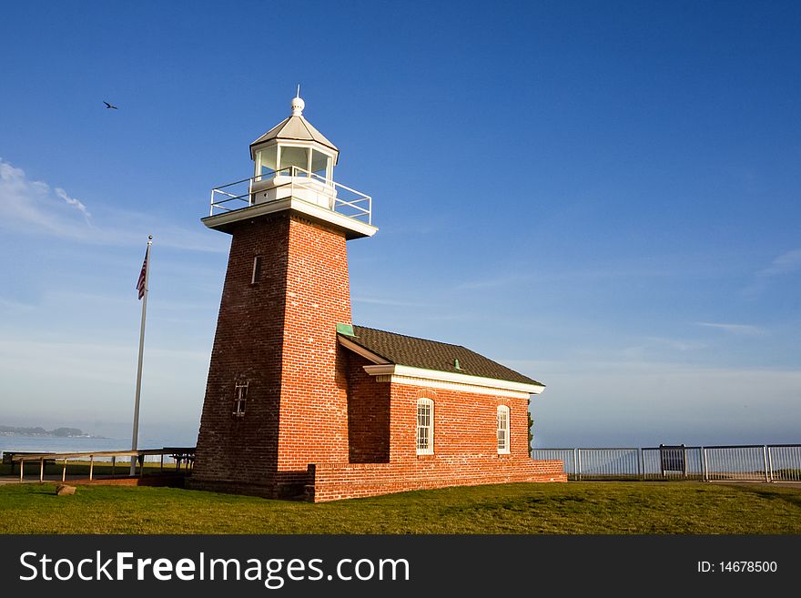 A light house with blue sky. It's located in Santa Cruz, California, United States. It's a landmark of Santa Cruz.