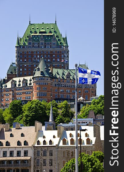 Flag of quebec blowing in front of historic castle on hill. Flag of quebec blowing in front of historic castle on hill