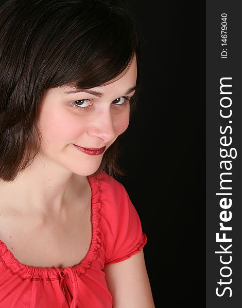 Portrait of a cute brunette female against a black background. Portrait of a cute brunette female against a black background