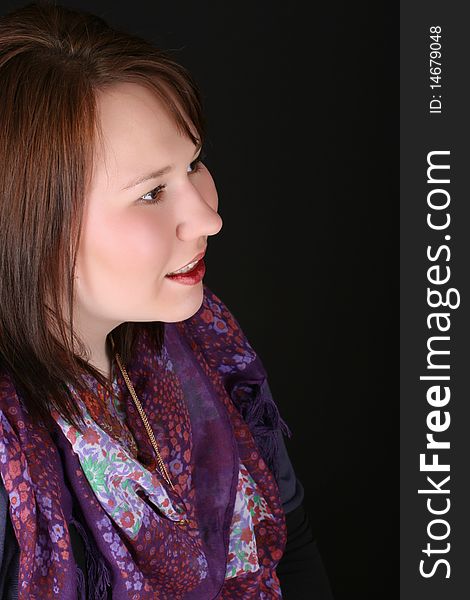 Headshot of beautiful brunette female on a black background