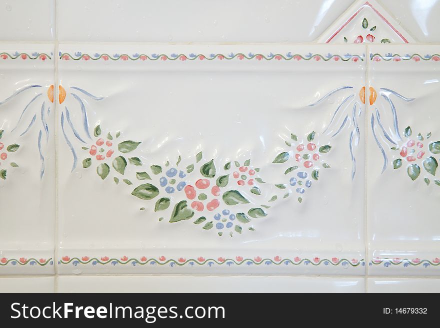 White Bathroom tiles with a floral pattern; in horizontal orientation