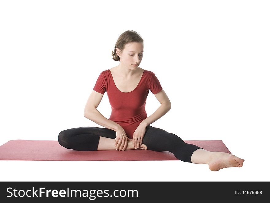 Woman exercising on a mat over white background. Woman exercising on a mat over white background