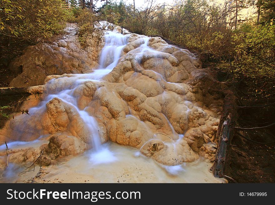 Misty stream running over yellow rocks .Sichuang.China. Misty stream running over yellow rocks .Sichuang.China