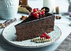 Dark Chocolate Cake Mozart , Red Currant On The Table A Cup Of Coffee, Cream Royalty Free Stock Photo