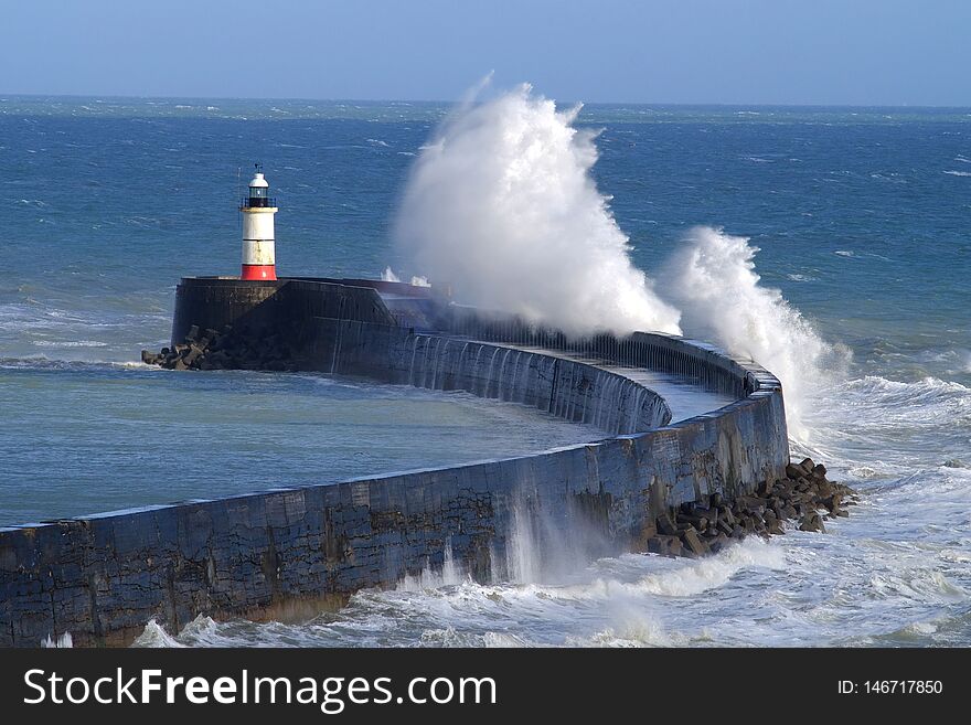 Large waves crashing over Newhaven harbour, East Sussex, UK. Large waves crashing over Newhaven harbour, East Sussex, UK