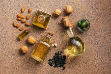 Flat Lay A Set Of Different Oil In Bottles, Almond, Walnut, Sunflower And Olive, Brown Background. View From Above Royalty Free Stock Images
