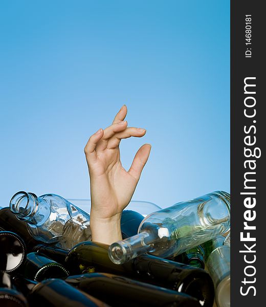 Human buried in a stack of glass bottles. Human buried in a stack of glass bottles