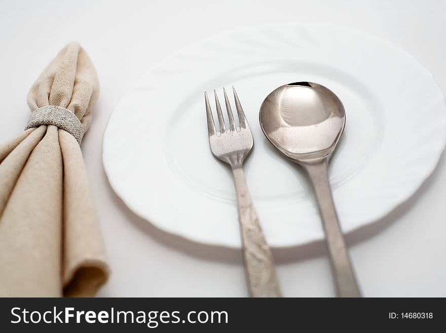 An image of fork, spoon and napkin. An image of fork, spoon and napkin