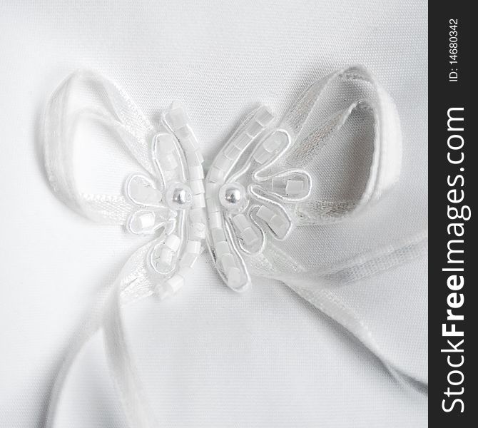 Beautiful detail of a white wedding rings pillow. Beautiful detail of a white wedding rings pillow