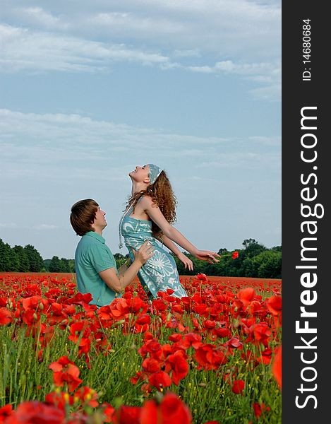 Loving couple in a field with poppies near Dnepropetrovsk .2010