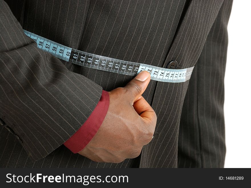 This is an image of a business man using a measuring tape. This is an image of a business man using a measuring tape.