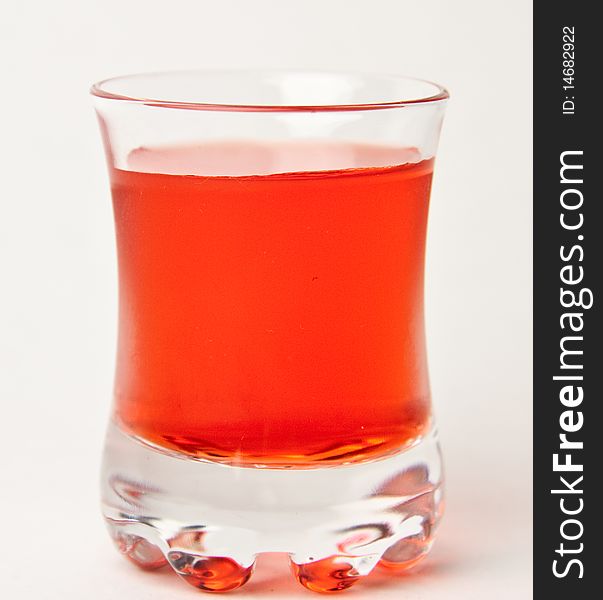 A Red drink standing behind a white background