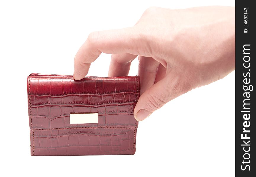 A hand holding a red purse over a white background