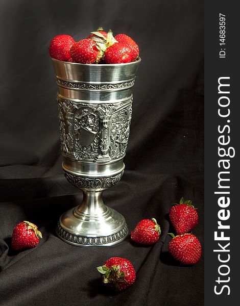 Red strawberrys with a silver cup. Red strawberrys with a silver cup