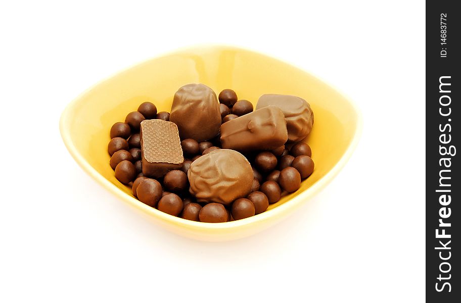 Assorted chocolate candy in yellow bowl