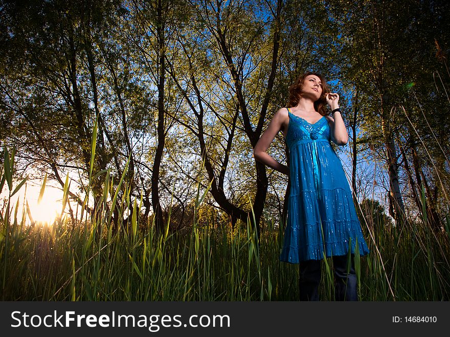 Young woman at uptown sunset reeds. Young woman at uptown sunset reeds