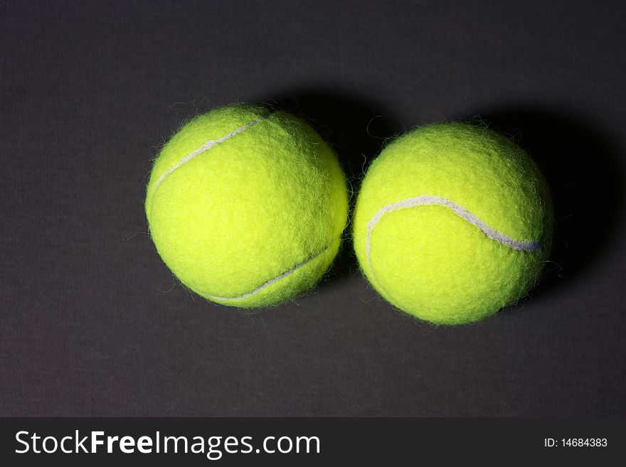 2 tennis balls on the gray background