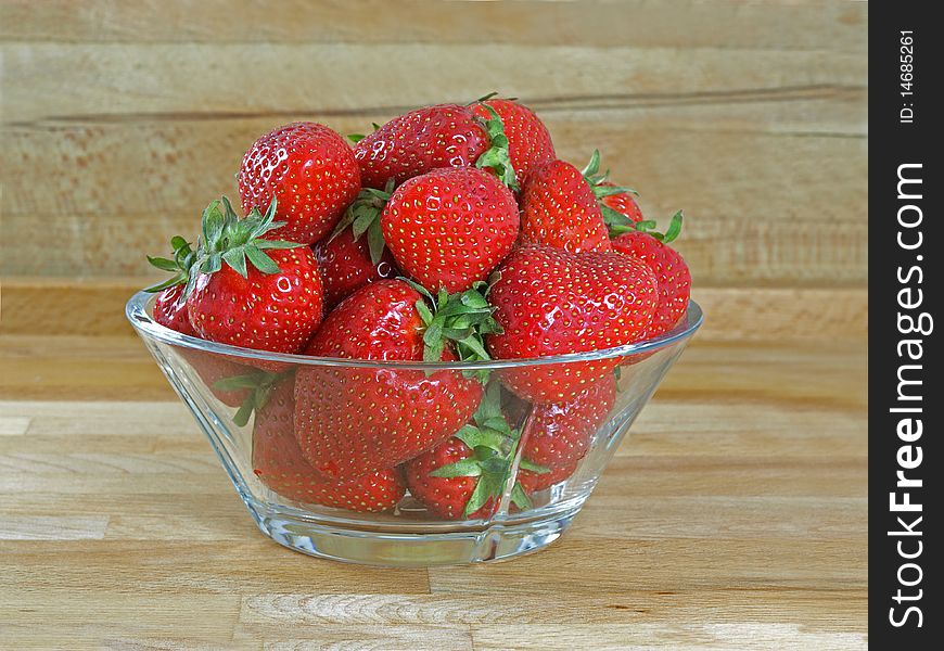 Fresh and juicy strawberries on glass bowl