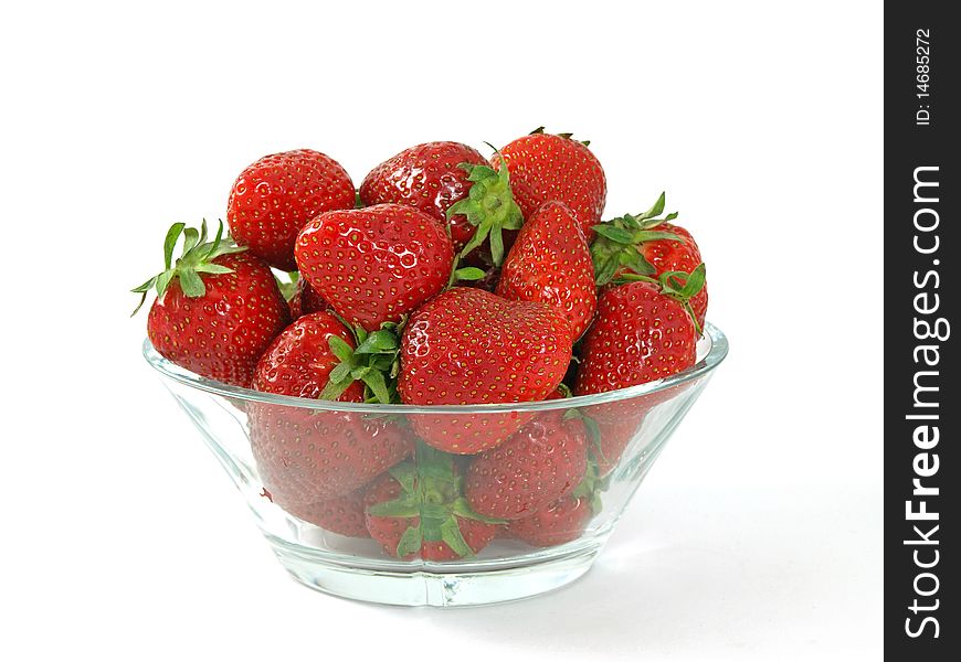 Fresh and juicy strawberries on glass bowl over white