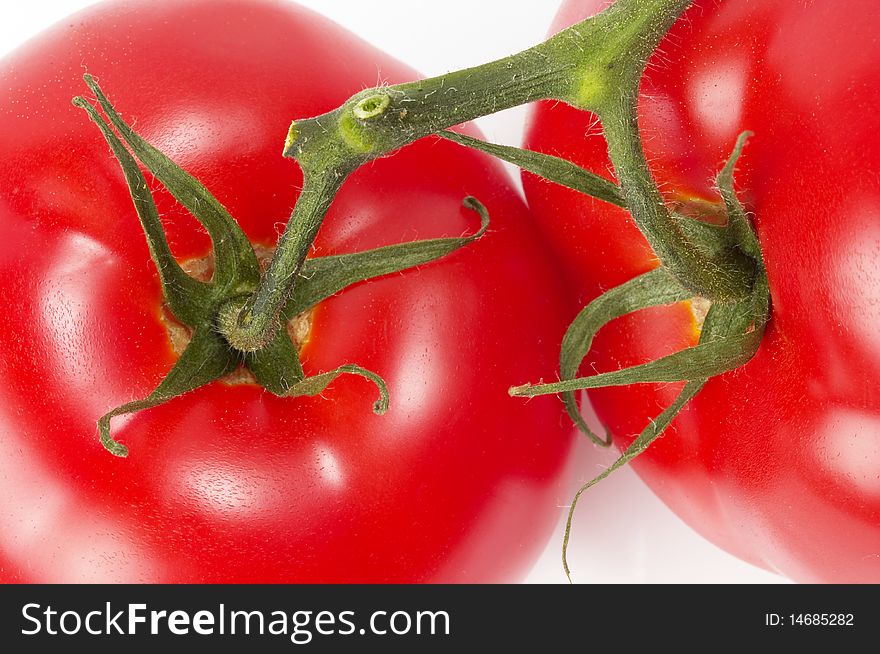 Two tomatoes fragment macro shot isolated over white background