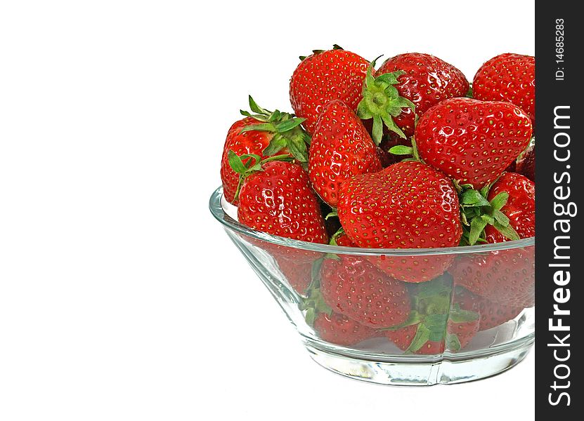 Fresh and juicy strawberries on glass bowl over white