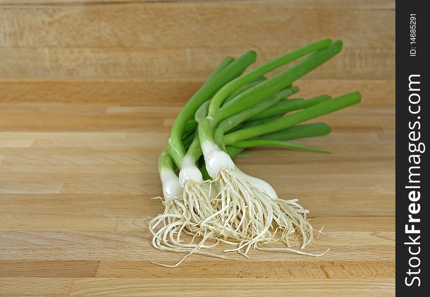 Fresh and green spring onions on cutting board. Fresh and green spring onions on cutting board