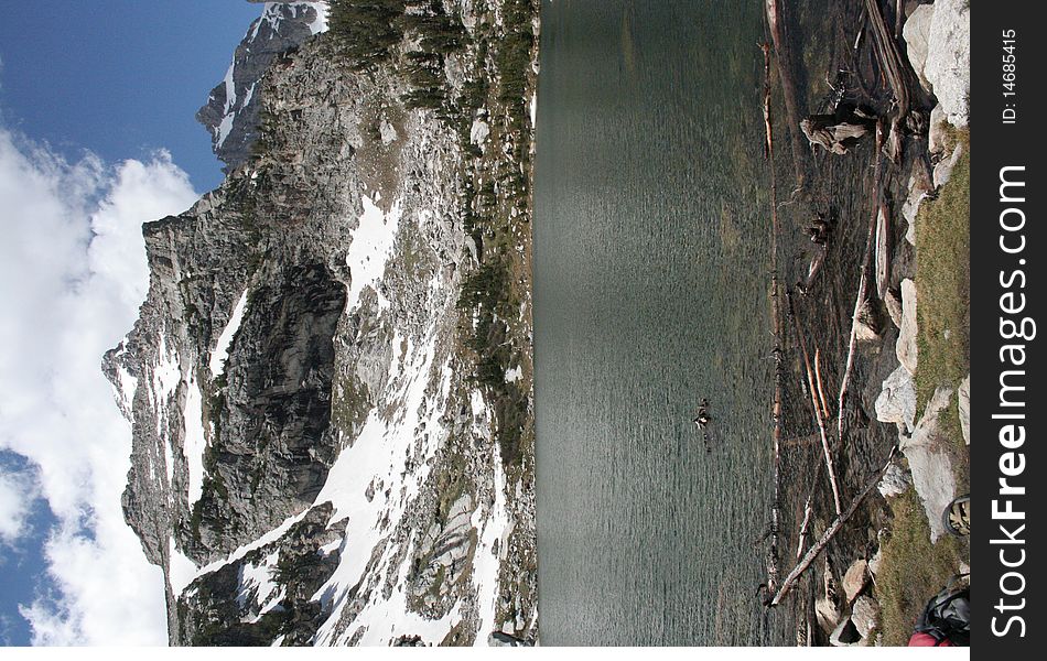 Despite this photo being taken in mid-June, this beautiful, crystal clear lake in the Grand Tetons of WY was surrounded by traces of snow on the mountains and terrain. Despite this photo being taken in mid-June, this beautiful, crystal clear lake in the Grand Tetons of WY was surrounded by traces of snow on the mountains and terrain.