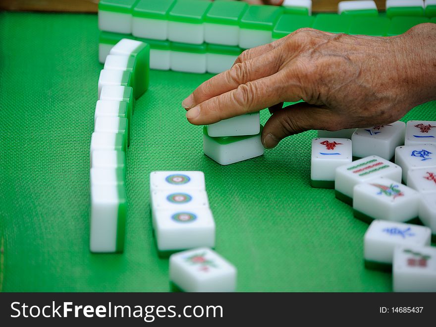 A hand making a move in a Chinese game.