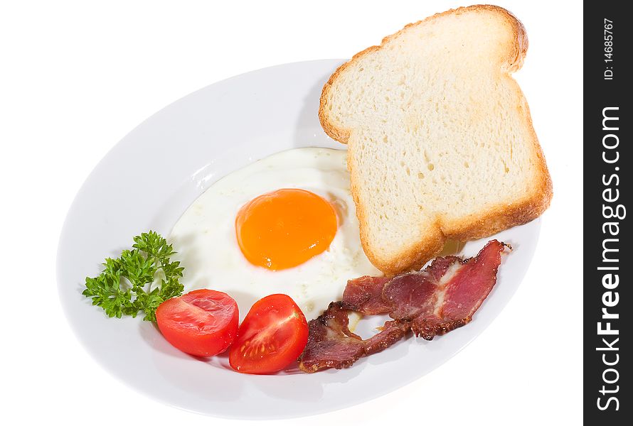 Fried egg, bacon vegetables on white background