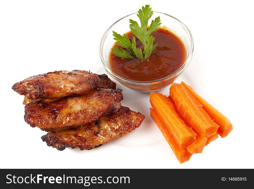 Chicken Buffalo Wings with carrot sticks and hot tomato sauce dip over white background. Chicken Buffalo Wings with carrot sticks and hot tomato sauce dip over white background