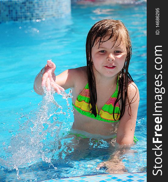 Girls playing in the pool with water. Girls playing in the pool with water