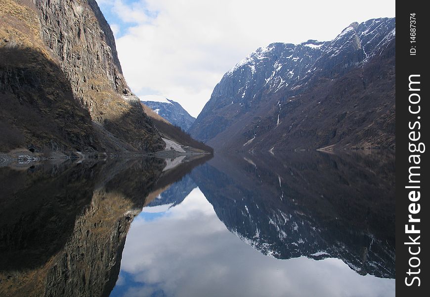 Fjord in Norway with a mountain reflexion in water