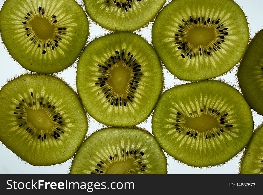 Kiwi fruit sliced and phographed on a light table