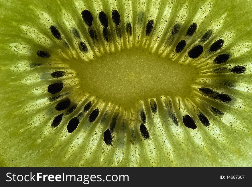 Slice of kiwi fruit close up on a light table