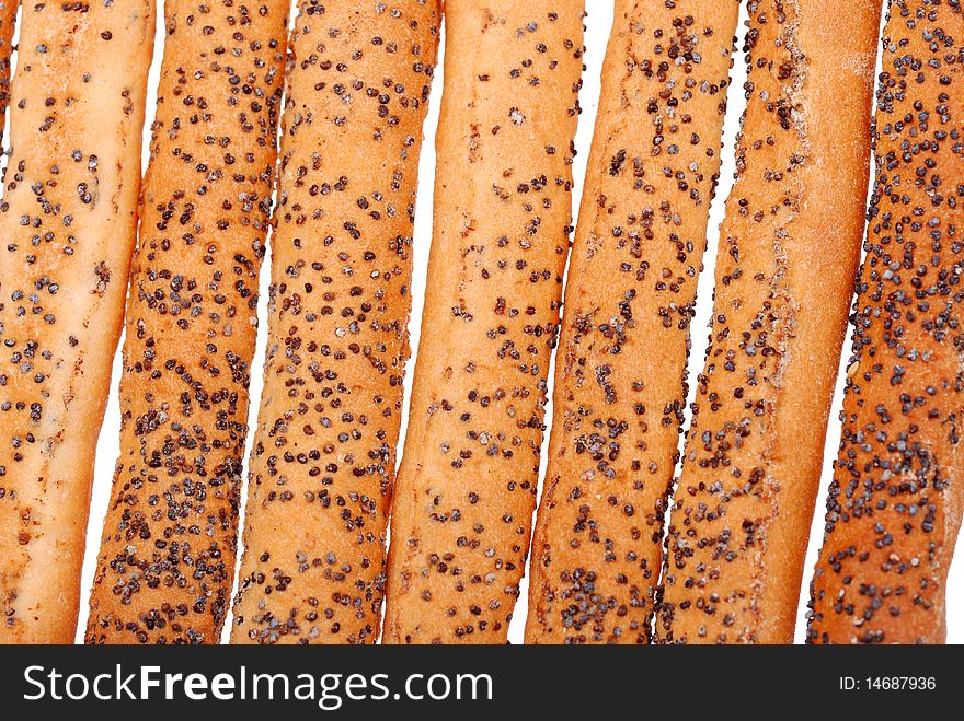 Stack of salted breadsticks with poppy seed isolated on white. Stack of salted breadsticks with poppy seed isolated on white