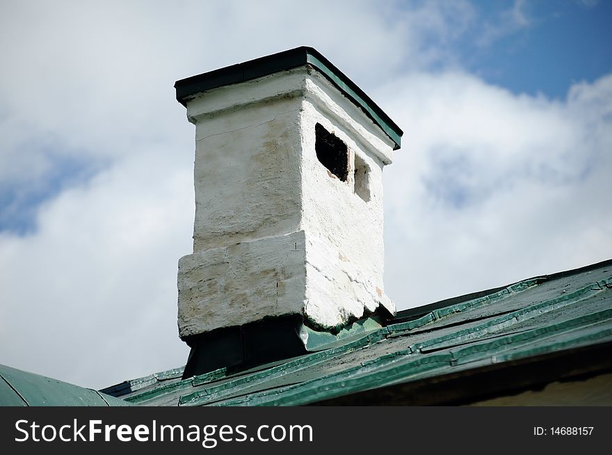 Brick elegant flue on a roof, painted with a white paint. Brick elegant flue on a roof, painted with a white paint