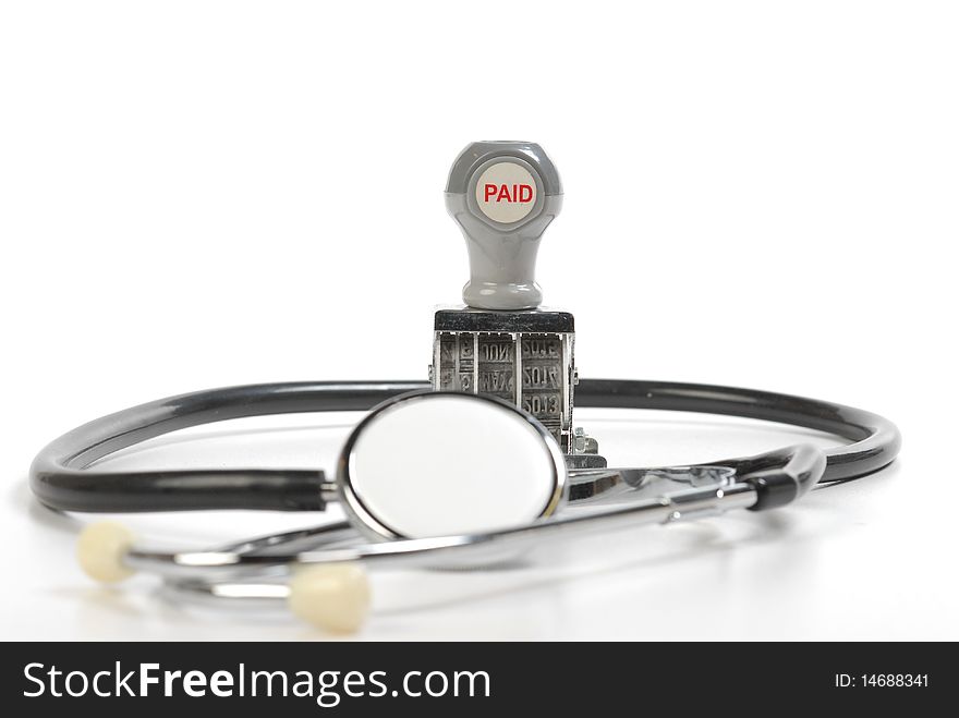 Stethoscope and paid stamp isolated on white. Stethoscope and paid stamp isolated on white