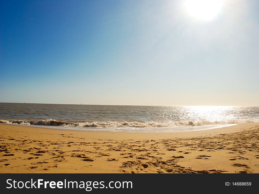 Beautiful seascape with sun, sky, ocean and sand