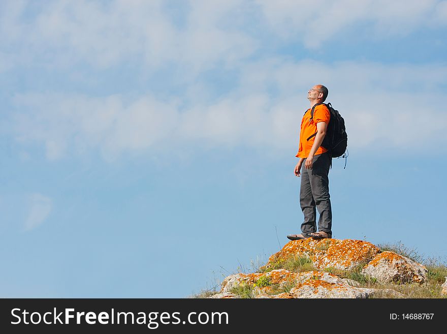 Hiker standing on sky background. Hiker standing on sky background