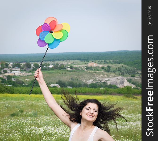 Young happy girl jumping in field with colorful flower. Young happy girl jumping in field with colorful flower