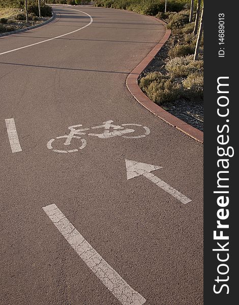 Cycle lane with bicycle symbol and arrow in the foreground. Cycle lane with bicycle symbol and arrow in the foreground