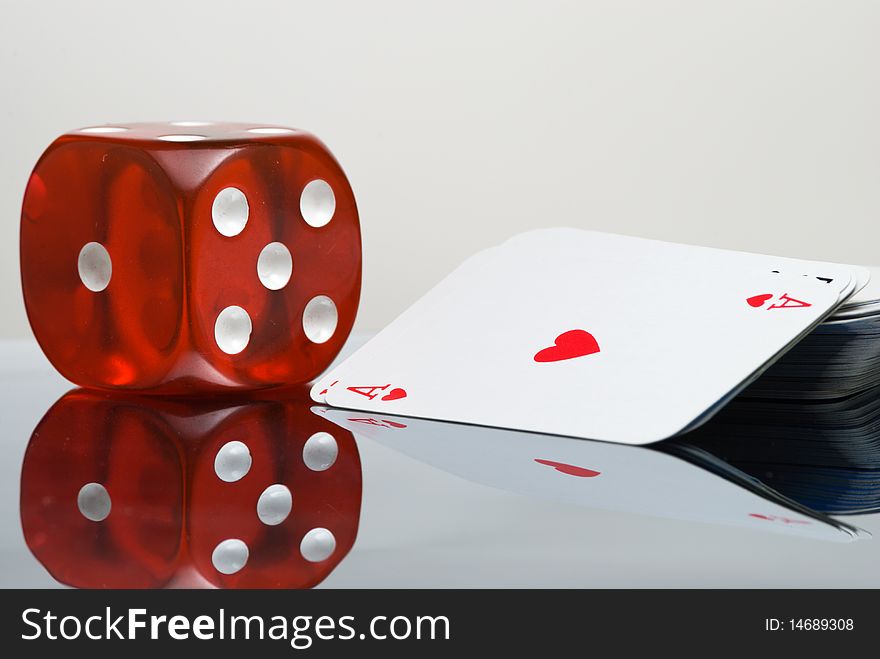 Red Dice and card deck with reflection